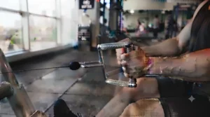 Variety of cable row handles mounted on a cable pulley system in a Canadian garage gym during winter training.