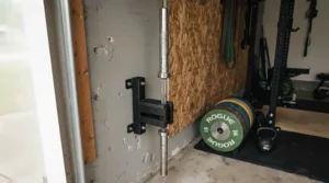 A 45lb olympic barbell stored vertically in a corner mount to save space at home.